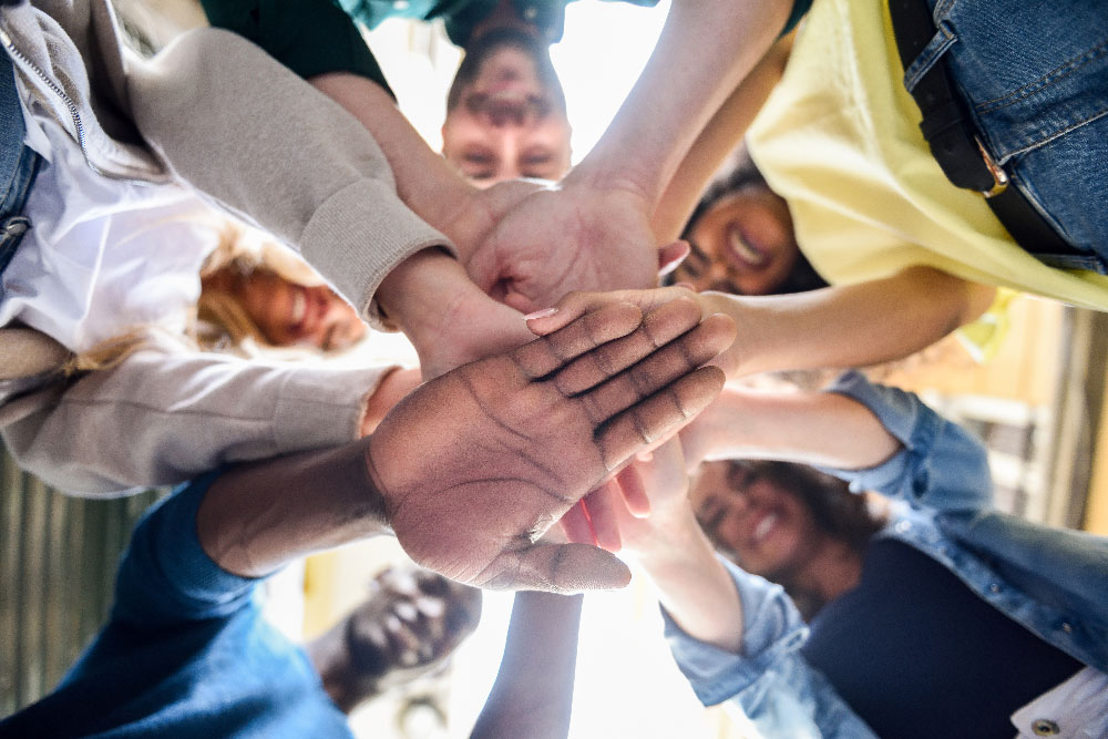 group of people holding hands in a circle